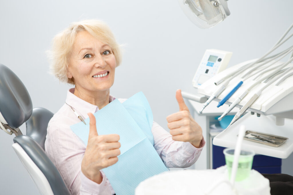 Happy senior woman at the dental clinic